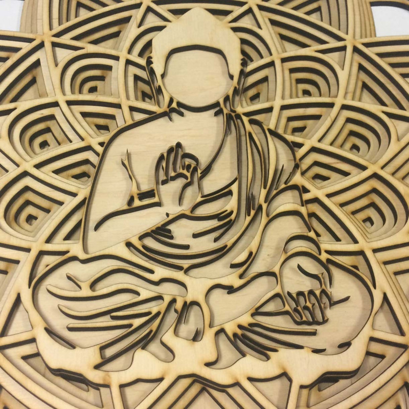 3D carved wooden mandala with a Buddha figure in a meditation position.