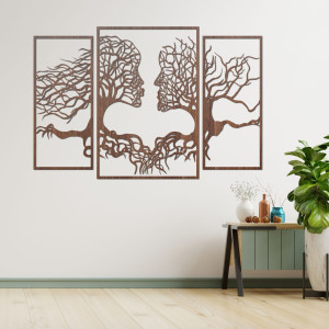 Wooden wall painting of faces and trees depicts the...