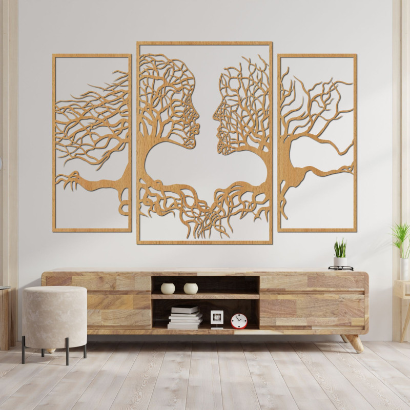 Wooden wall painting of faces and trees depicts the connection between man and nature