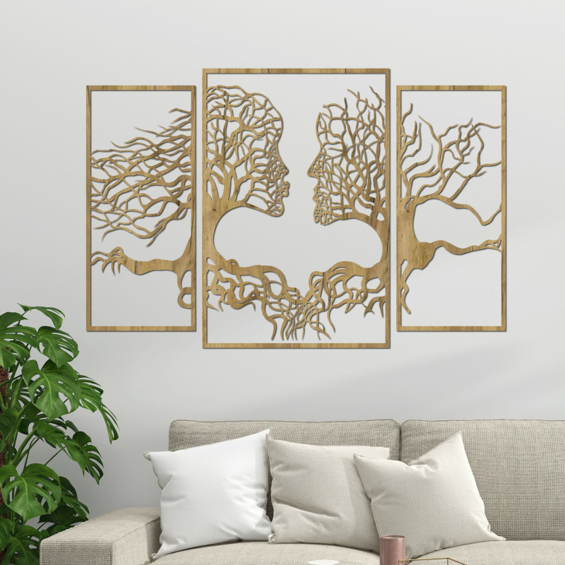 Wooden wall painting of faces and trees depicts the connection between man and nature