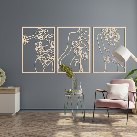 Elegant three-part painting of a woman with floral elements on the wall