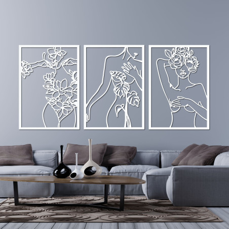 Elegant three-part painting of a woman with floral elements on the wall