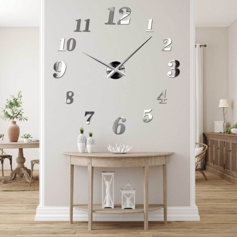 Adhesive wall clock made of black plexiglass on a white wall