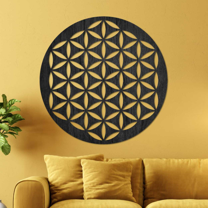 Wooden wall decoration with a geometric flower of life pattern displayed on a light wall.