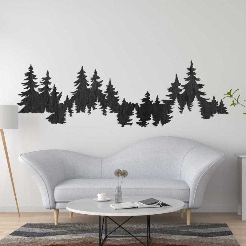 Close-up view of a forest silhouette made of wood mounted on a white wall.