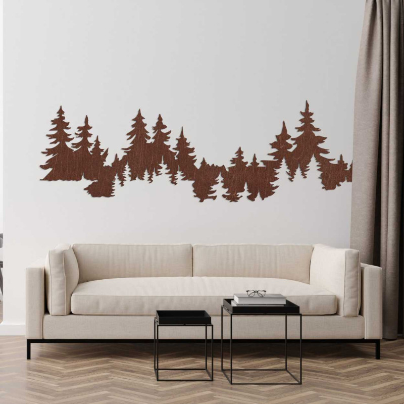 Close-up view of a forest silhouette made of wood mounted on a white wall.