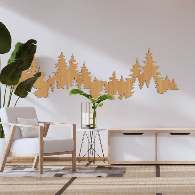 Close-up view of a forest silhouette made of wood mounted on a white wall.