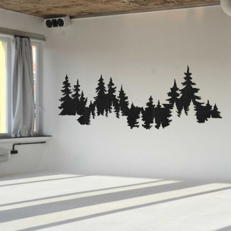 Close-up view of a forest silhouette made of wood mounted on a white wall.