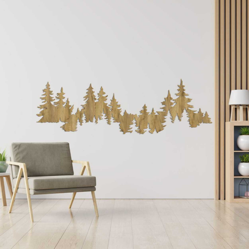 Close-up view of a forest silhouette made of wood mounted on a white wall.