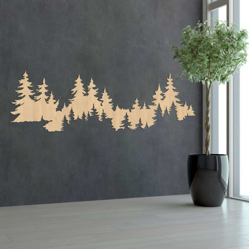 Close-up view of a forest silhouette made of wood mounted on a white wall.