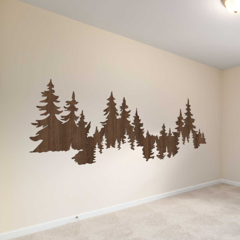 Close-up view of a forest silhouette made of wood mounted on a white wall.