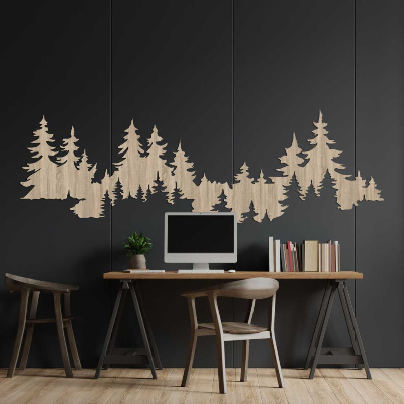 Close-up view of a forest silhouette made of wood mounted on a white wall.
