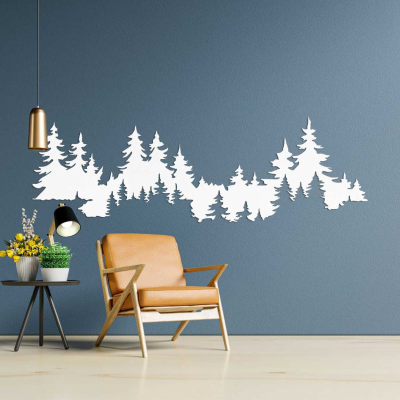 Close-up view of a forest silhouette made of wood mounted on a white wall.