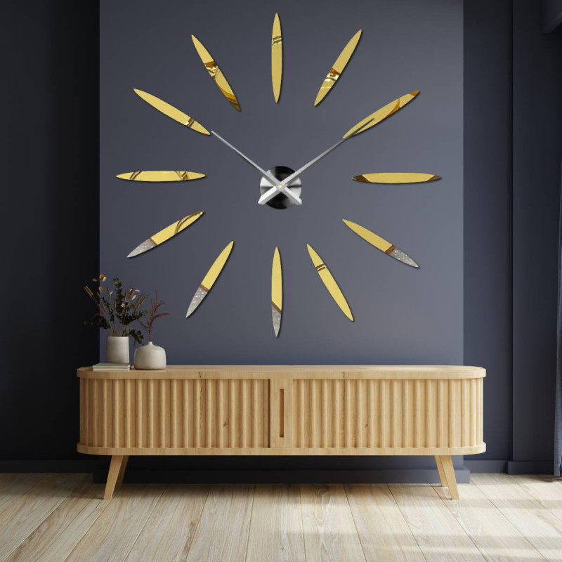 Wall clock with large gold indexes and silver hands, glued directly to the wall