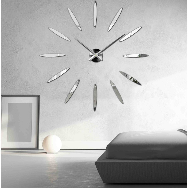 Wall clock with large gold indexes and silver hands, glued directly to the wall