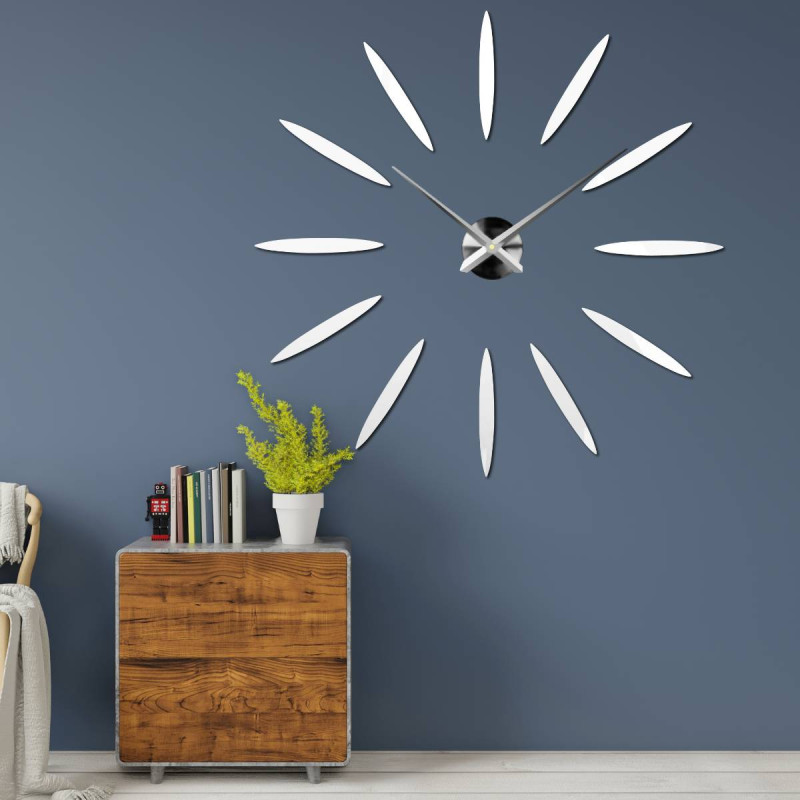 Wall clock with large gold indexes and silver hands, glued directly to the wall