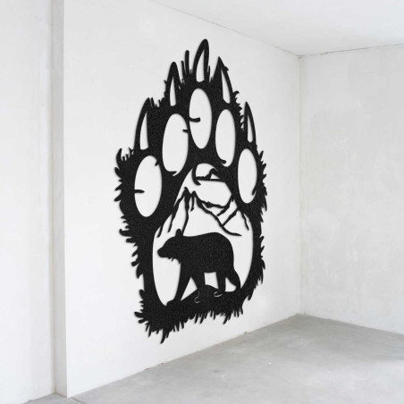 A close-up view of a natural motif of a bear and mountains inside a large wooden paw. A close-up view of a natural motif of a bear and mountains inside a large wooden paw.