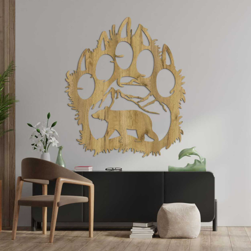 A close-up view of a natural motif of a bear and mountains inside a large wooden paw.