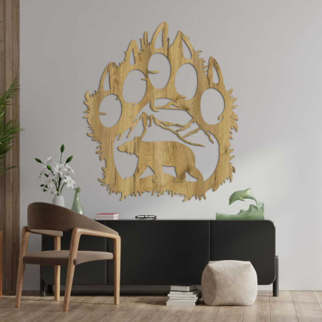 Hand-carved decoration depicting a bear walking under a mountain range. Hand-carved decoration depicting a bear walking under a mountain range.