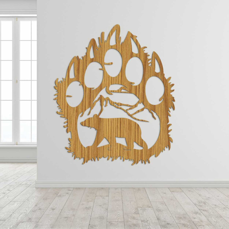 A close-up view of a natural motif of a bear and mountains inside a large wooden paw.