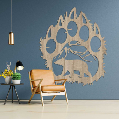 A carved nature motif enclosed in the dramatic silhouette of a bear's paw. A carved nature motif enclosed in the dramatic silhouette of a bear's paw.