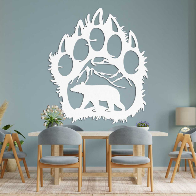 A close-up view of a natural motif of a bear and mountains inside a large wooden paw.