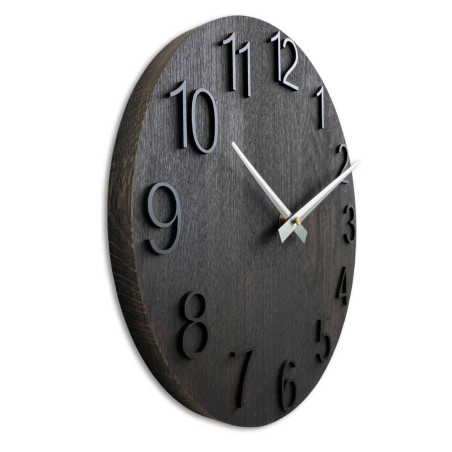 A wooden decorative element in the shape of a clock with carved numbers and a clean style.