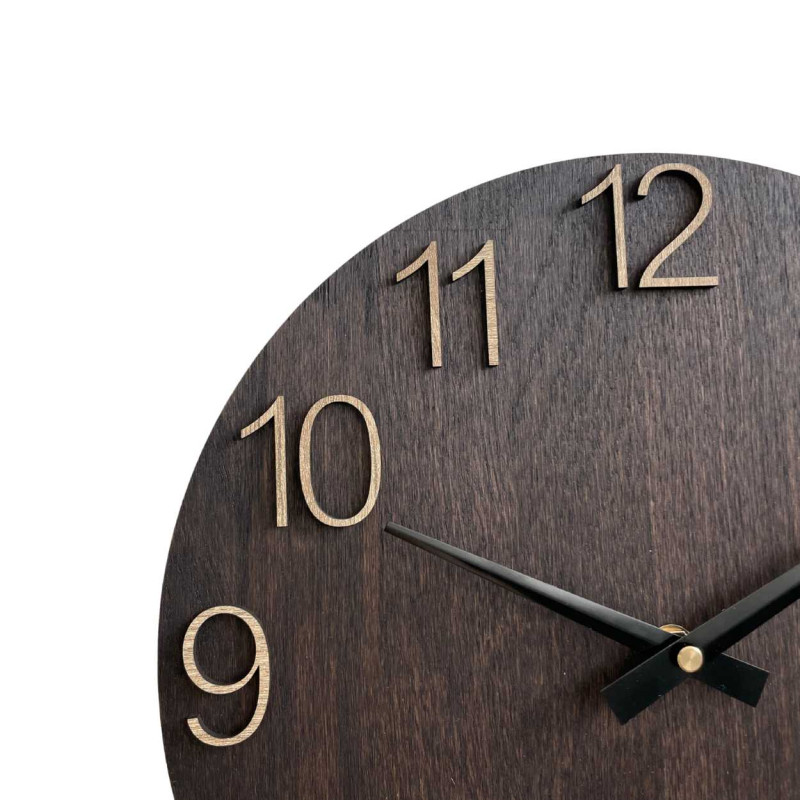 Wooden wall clock with carved numbers and metal hands.