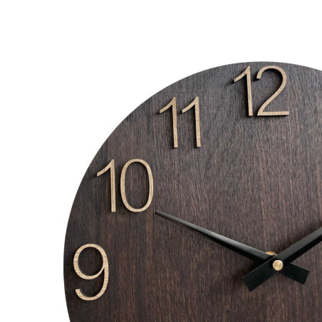 Wooden wall clock with carved numbers and metal hands.