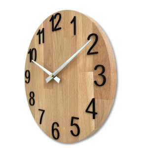 Carved wooden clock with a simple dial and minimalist design.