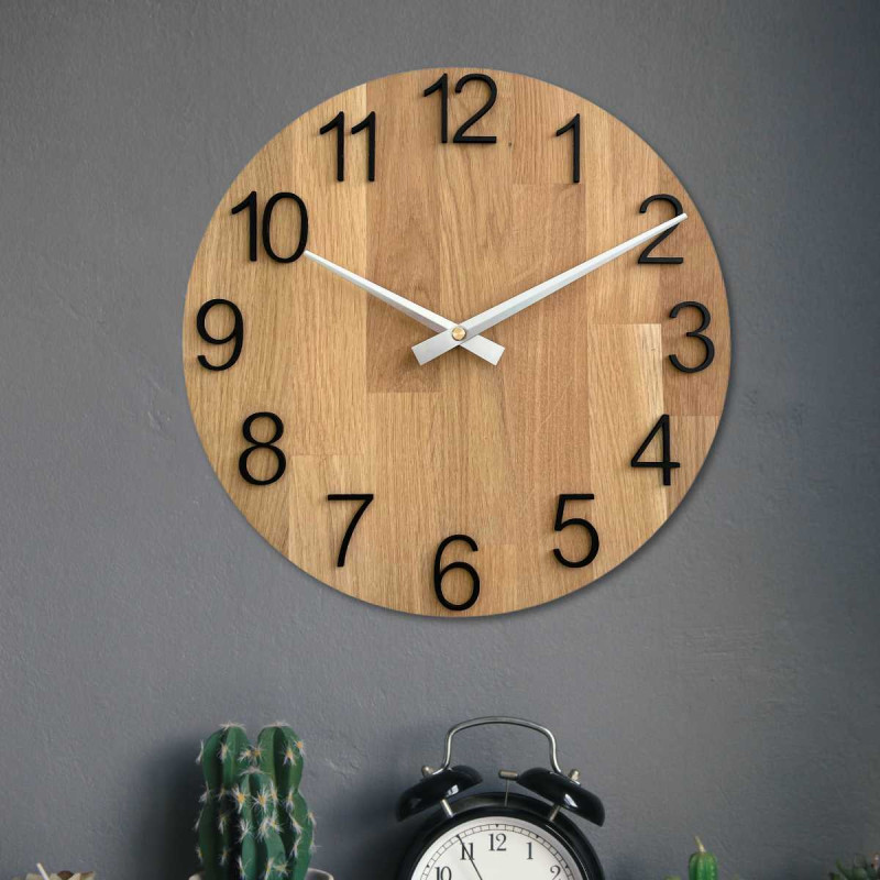 Wooden wall clock with a circular shape and a subtle natural motif.
