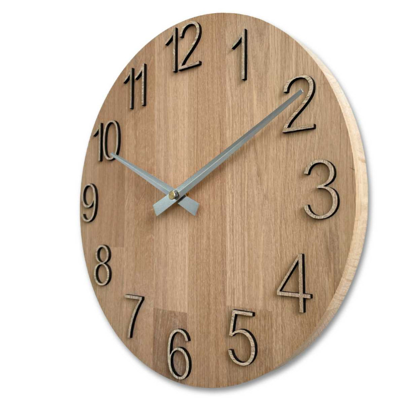 Wooden clock with a symmetrical shape and a cutout inspired by motifs from nature.
