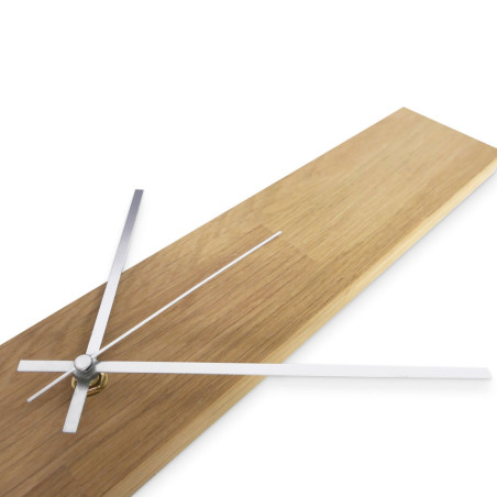 Minimalist clock with a wooden base and black hands, without numbers.