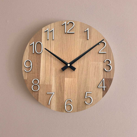 Natural wooden clock with a simple design and thin hands. Natural wooden clock with a simple design and thin hands.