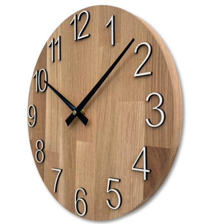 Round clock with a decorative cutout in the center and a delicate wood pattern. Round clock with a decorative cutout in the center and a delicate wood pattern.