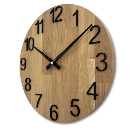Round clock made of natural wood with contrasting metal hands. Round clock made of natural wood with contrasting metal hands.
