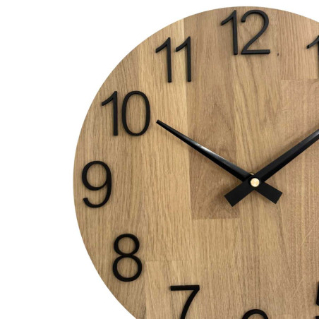 Clock made of solid wood with engraved numbers and a natural pattern. Clock made of solid wood with engraved numbers and a natural pattern.