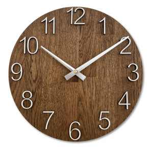 Wooden clock with a symmetrical shape and a cutout inspired by motifs from nature.