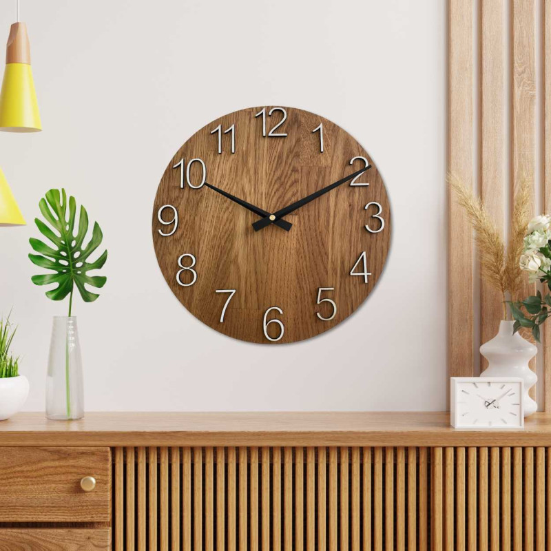 Wooden clock with a symmetrical shape and a cutout inspired by motifs from nature.