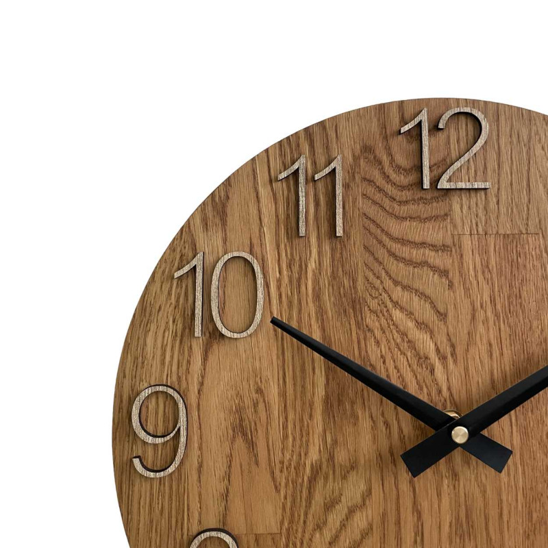 Carved wooden clock with a simple dial and minimalist design.