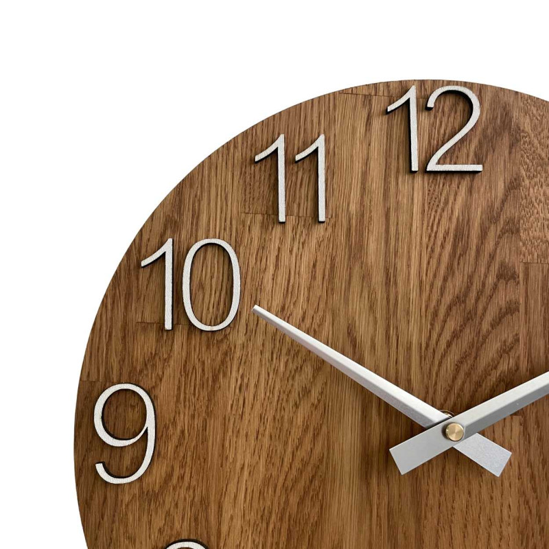 Round clock made of natural wood with contrasting metal hands.
