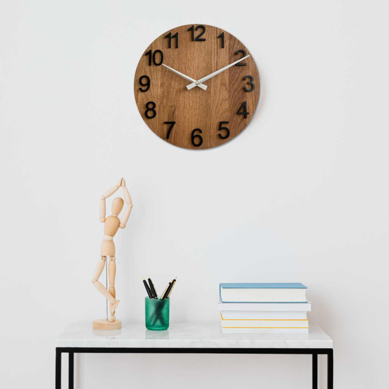Natural wooden clock with a simple design and thin hands.