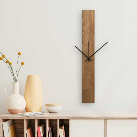 Wall clock with a narrow wooden panel and hands in black and silver.