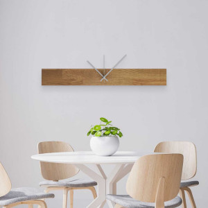 Wooden wall clock with a round dial and black hands.