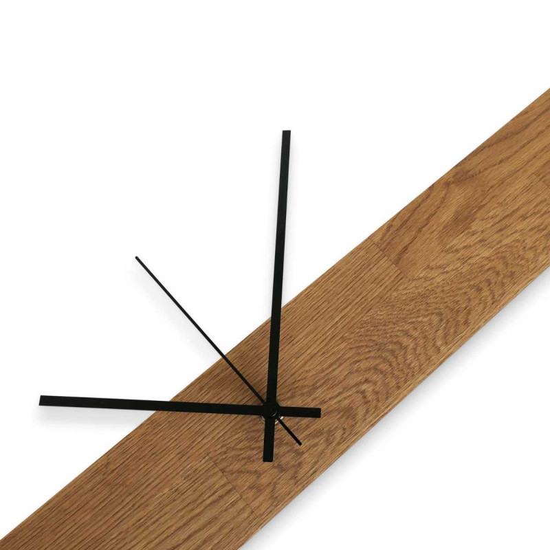 Minimalist wall clock with a wooden base and contrasting hands.