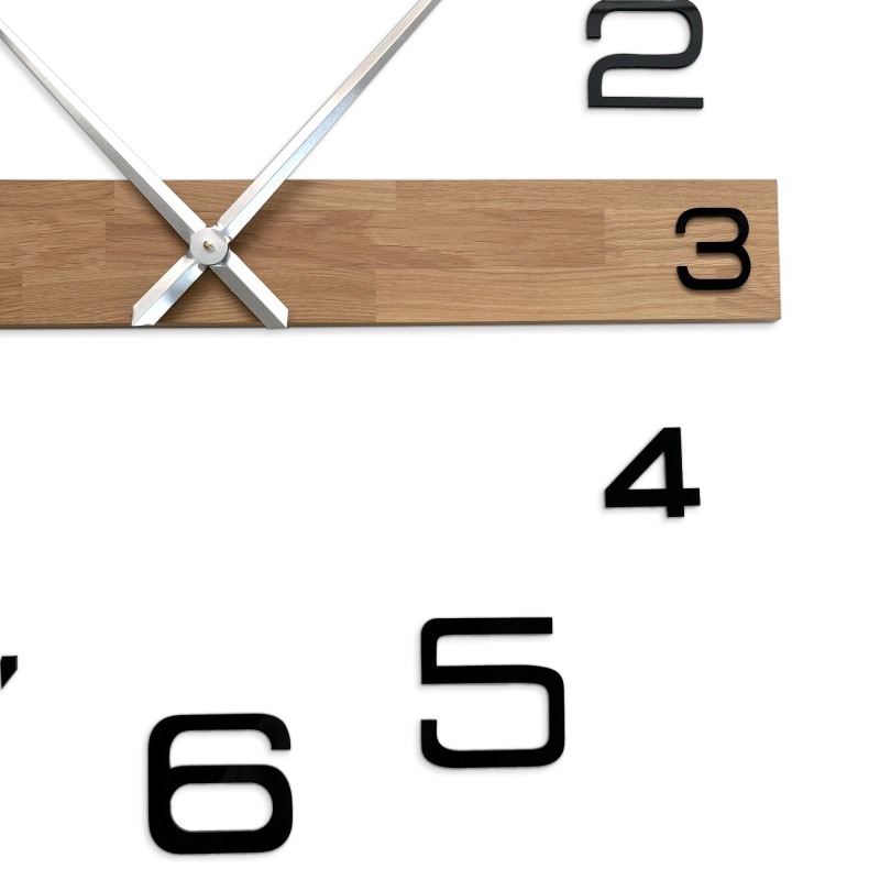 Modern wooden wall clock with large black numbers and elegant hands.