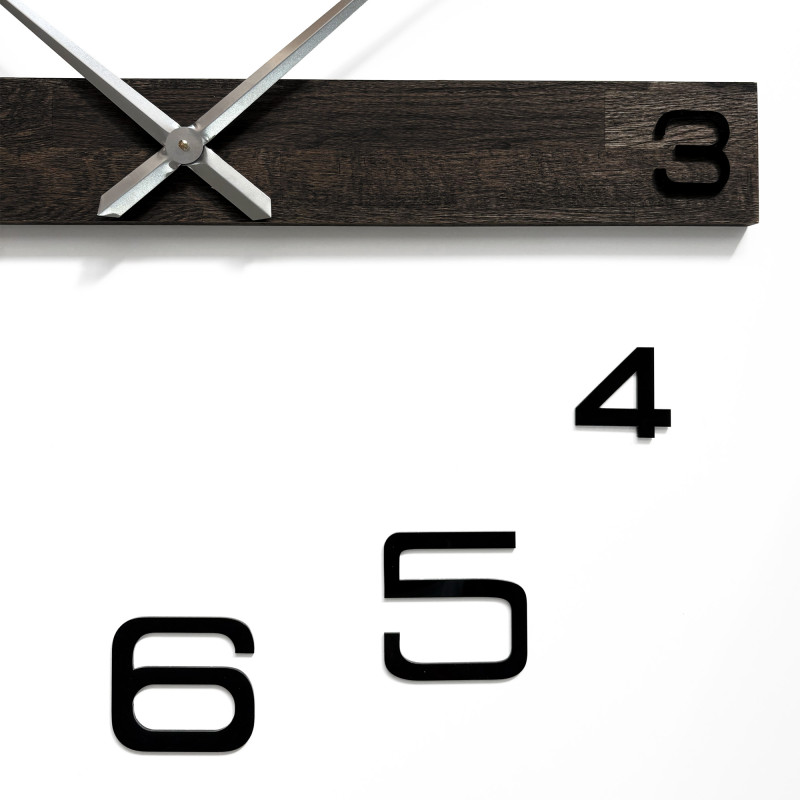 Stylish wooden clock for the living room with distinctive numbers and elegant hands.
