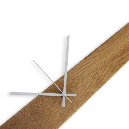 Elegant wooden clock with a dark wooden top and black numerals arranged on the wall.