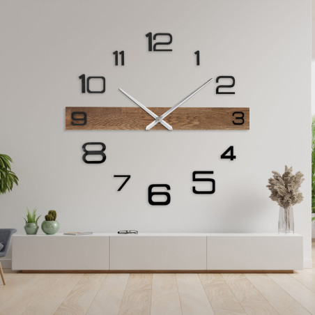 Elegant wooden clock with a dark wooden top and black numerals arranged on the wall. Elegant wooden clock with a dark wooden top and black numerals arranged on the wall.