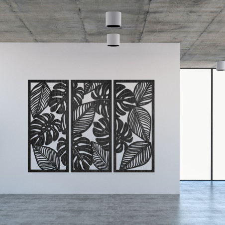 Modern wall decoration: three panels with cutouts of monstera leaves.